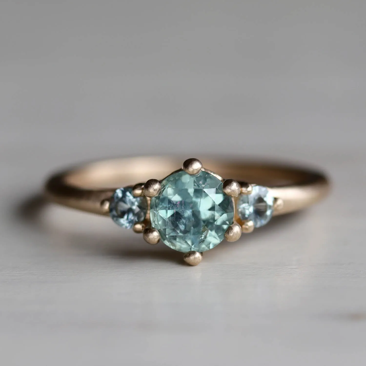 Three Stone Low Base Ring with Green Montana and Pale Teal Sapphires